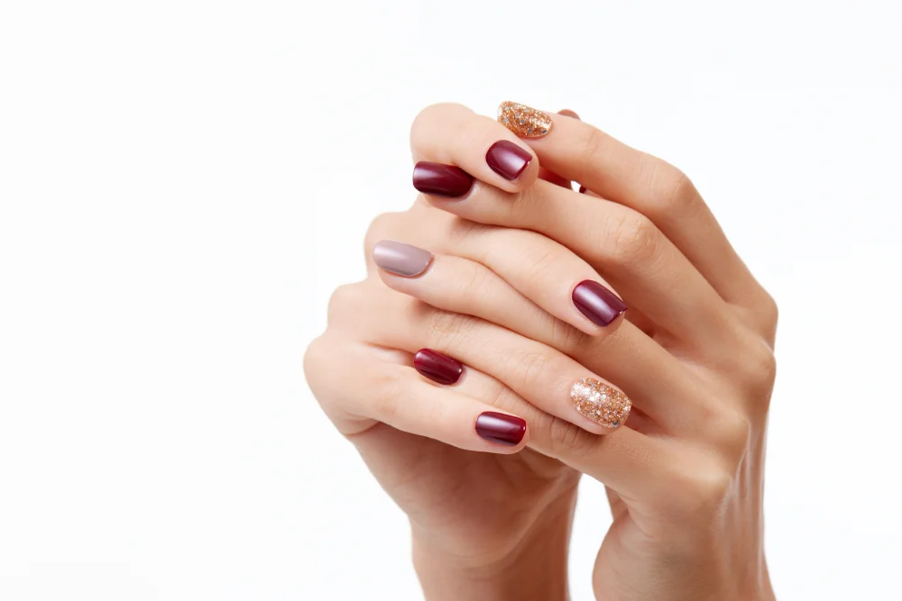closeup shot female s hands with beautiful nail polish white background