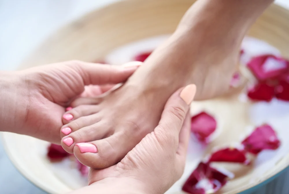 woman s feet bowl with water petal